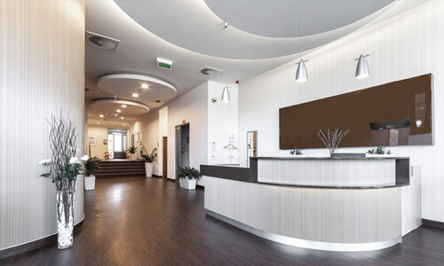 Picture of a dental office interior representing the dental services of the Costa Rica Dental Centre in San Jose, Costa Rica. The interior is very modern and has soft brown and white colors.